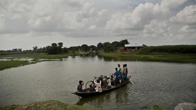 Muslims arrive in a boat to check if their names are included in the National Register of Citizens (NRC) at a draft center in Bur Gaon village. Home minister Rajnath Singh on Friday dispelled fears that the draft NRC in Assam would be used to take coercive action against genuine citizens, and condemned alleged attempts by political parties to disrupt communal harmony over the issue. (Anupam Nath / AP File) Muslims arrive in a boat to check if their names are included in the National Register of Citizens (NRC) at a draft center in Bur Gaon village. Home minister Rajnath Singh on Friday dispelled fears that the draft NRC in Assam would be used to take coercive action against genuine citizens, and condemned alleged attempts by political parties to disrupt communal harmony over the issue. (Anupam Nath / AP File)