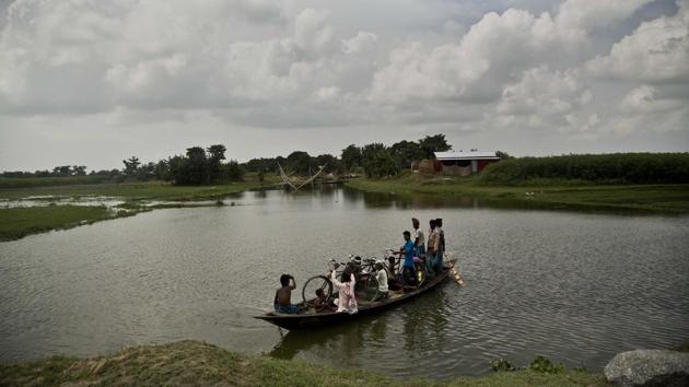 Muslims arrive in a country boat to check if their names are included in the National Register of Citizens at a draft center in Bur Gaon village, 70 kilometers east of Guwahati, Assam on July 30, 2018. (Anupam Nath / AP) Muslims arrive in a country boat to check if their names are included in the National Register of Citizens at a draft center in Bur Gaon village, 70 kilometers east of Guwahati, Assam on July 30, 2018. (Anupam Nath / AP)