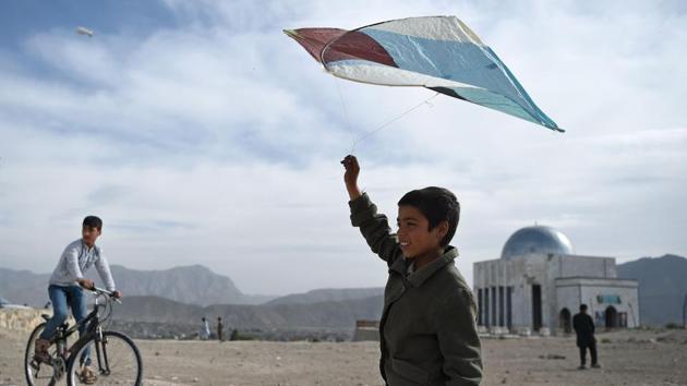 An Afghan boy prepares to fly a kite during a kite battle on a hillside in Kabul. After selling hundreds of thousands of kites during the cooler months, particularly in spring when flying conditions are ideal, kite makers spend the rest of the year replenishing their stocks. (Wkil Kohsar / AFP) An Afghan boy prepares to fly a kite during a kite battle on a hillside in Kabul. After selling hundreds of thousands of kites during the cooler months, particularly in spring when flying conditions are ideal, kite makers spend the rest of the year replenishing their stocks. (Wkil Kohsar / AFP)