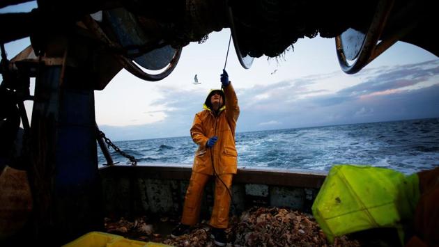French fisherman Victor, 21-years-old, sorts through a catch on board the ‘Nounoute’ trawler during a 17-hours fishing trip off the coast of Ouistreham, northwestern France. This 45-year-old trawler catches Flounder during the night and Mackerel during the day. (Charly Triballeau / AFP) French fisherman Victor, 21-years-old, sorts through a catch on board the ‘Nounoute’ trawler during a 17-hours fishing trip off the coast of Ouistreham, northwestern France. This 45-year-old trawler catches Flounder during the night and Mackerel during the day. (Charly Triballeau / AFP)