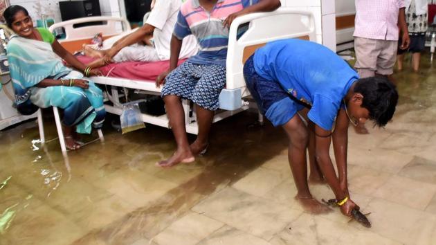 A relative of a patient catches a fish inside a waterlogged hospital ward at Nalanda Medical College and Hospital (NMCH) following heavy monsoon rains in Patna, Bihar on July 29, 2018. (AFP) A relative of a patient catches a fish inside a waterlogged hospital ward at Nalanda Medical College and Hospital (NMCH) following heavy monsoon rains in Patna, Bihar on July 29, 2018. (AFP)