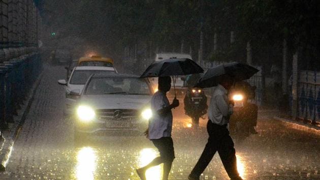 Pedestrians walk across a road during monsoon rainfall, in Kolkata on Friday, Aug 3, 2018. ((PTI)