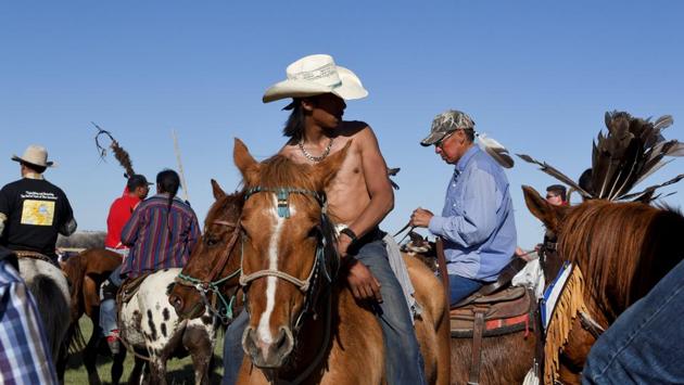 The Fort Laramie Treaty riders take a break after arriving at the Fort Laramie National Historic Site, Wyoming. Reaching Fort Laramie was a triumph given the long, arduous ride and momentous occasion being celebrated. Riders circled ceremonial tepees and crossed a river to the site of the signing. (Stephanie Keith / REUTERS)