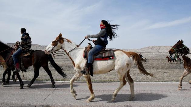 Stephanie Big-Eagle rides with other treaty riders on the Pine Ridge Reservation in South Dakota. In 2018, to mark the 150th anniversary of the Fort Laramie peace treaty between the Sioux Nation and US government, the Lakota (Sioux) people embarked on a 640 km ride from Green Grass, South Dakota, home to their spiritual leader, Arvol Lookinghorse to Fort Laramie, Wyoming. (Stephanie Keith / REUTERS)