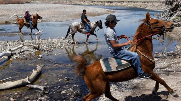 Some people brought horses in trailers. They said Arvol had 100 horses, some wild, some broken. He offered several to relatives and others for the ride. After a prayer, a motivational speech and song, the riders headed up a hill and out of sight. There was great pride among them. (Stephanie Keith / REUTERS)