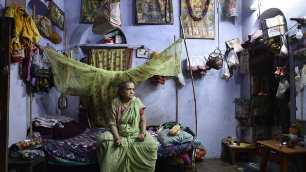 “This is my world,” said Gulabi Bai, surrounded by laminated posters of Shiva, Saraswati and Krishna pasted on a wall, a French window converted into a prayer section and clothes hanging on a line above the headrest. Fruits and vegetables, kept in polythene bags, hang on a thick string fastened to the walls. “Moksha is nowhere else but here,” she said in her sharp voice. (Sanchit Khanna / HT Photo) “This is my world,” said Gulabi Bai, surrounded by laminated posters of Shiva, Saraswati and Krishna pasted on a wall, a French window converted into a prayer section and clothes hanging on a line above the headrest. Fruits and vegetables, kept in polythene bags, hang on a thick string fastened to the walls. “Moksha is nowhere else but here,” she said in her sharp voice. (Sanchit Khanna / HT Photo)
