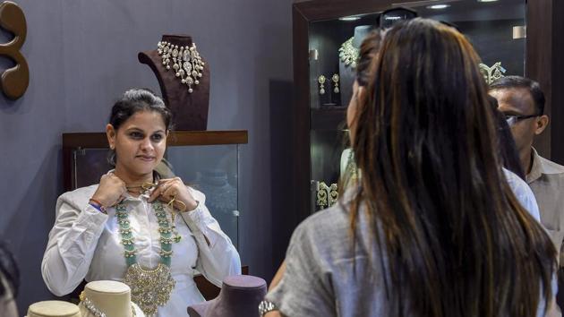 A visitor at a jewellery vendor's stall during Vogue Wedding Show 2018. (PTI) A visitor at a jewellery vendor's stall during Vogue Wedding Show 2018. (PTI)