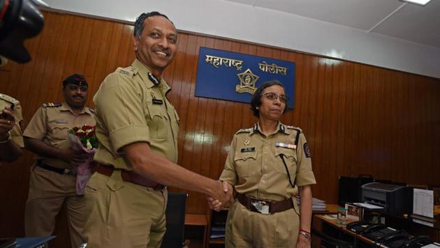 K Venkatesham (left) and Rashmi Shukla share light moment as Venkatesham takes charge as the police commissioner at the police commissioner office on Friday. (Pratham Gokhale/HT Photo)