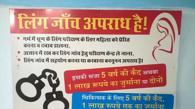 A signboard displayed at a community health centre warns against sex determination at Raipur in Dehradun.(HT File)