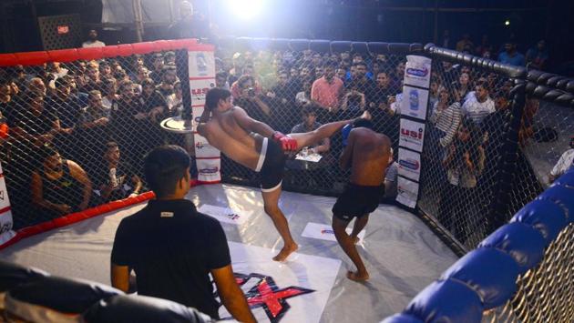 Mixed martial arts fighters in action during the first match of an amateur fighting event held at High spirits on Wednesday. (Shankar Narayan/HT PHOTO)