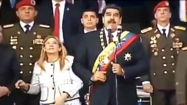 Screengrab taken from a handout video released by Venezuelan Television (VTV) showing Venezuelan President Nicolas Maduro (C), his wife Cilia Flores (L) and military authorities reacting to a loud band during a ceremony to celebrate the 81st anniversary of the National Guard in Caracas on August 4.(AFP Photo)