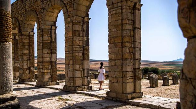 Tourists walk through the ruins of the ancient Roman site of Volubilis, near the town of Moulay Idriss Zerhounon in Morocco's north central Meknes region, on July 25, 2018. (AFP) Tourists walk through the ruins of the ancient Roman site of Volubilis, near the town of Moulay Idriss Zerhounon in Morocco's north central Meknes region, on July 25, 2018. (AFP)