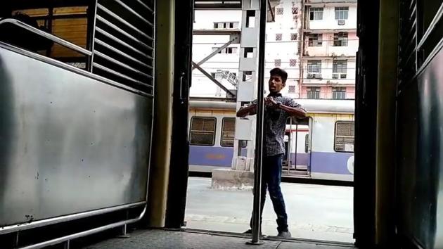 The video starts with a youth dancing along a moving local train at CSMT. (HT) The video starts with a youth dancing along a moving local train at CSMT. (HT)