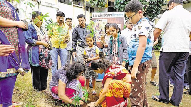 Residents of Dhankawade Patil township cooperative housing society planted indigenous tree saplings in their society on Saturday. (RAHUL RAUT/HT) Residents of Dhankawade Patil township cooperative housing society planted indigenous tree saplings in their society on Saturday. (RAHUL RAUT/HT)