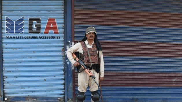 A paramilitary trooper stands guard in front of closed shops on the second day of strikes called by Kashmiri separatists against attempts to revoke articles 35A and 370 in downtown Srinagar on August 6, 2018. (AFP) A paramilitary trooper stands guard in front of closed shops on the second day of strikes called by Kashmiri separatists against attempts to revoke articles 35A and 370 in downtown Srinagar on August 6, 2018. (AFP)