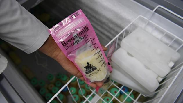 A nurse holds a packet of breast milk stored in a freezer at a milk bank at Fortis La Femme hospital. “We must urgently scale up support to mothers -- be it from family members, health care workers, employers and governments, so they can give their children the start they deserve,” WHO director general Tedros Adhanom Ghebreyesus said in the report. (Sajjad Hussain / AFP) 