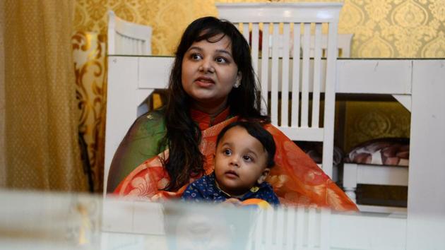 Neha Rastogi with her son Avyaan at their residence in Noida. The signs are good that their case may make some progress, with the court demanding city authorities come up with a response at the next hearing day on August 28. (Sajjad Hussain / AFP) 