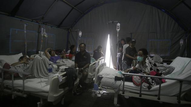Patients were evacuated to a tent outside a hospital, in Bali. Indonesia is prone to earthquakes because of its location on the Pacific “Ring of Fire,” an arc of volcanoes and fault lines in the Pacific Basin. In December 2004, a massive magnitude 9.1 earthquake off Sumatra island triggered a tsunami that killed 230,000 people in a dozen countries. (Firdia Lisnawati / AP) Patients were evacuated to a tent outside a hospital, in Bali. Indonesia is prone to earthquakes because of its location on the Pacific “Ring of Fire,” an arc of volcanoes and fault lines in the Pacific Basin. In December 2004, a massive magnitude 9.1 earthquake off Sumatra island triggered a tsunami that killed 230,000 people in a dozen countries. (Firdia Lisnawati / AP)