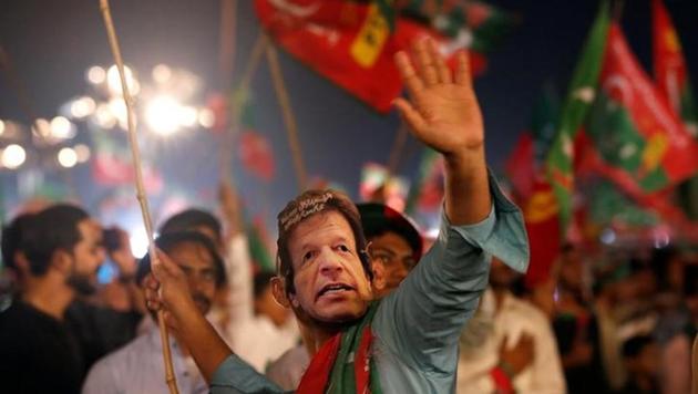 A supporter of Imran Khan wears a mask and dance on party songs during a campaign rally ahead of general elections in Karachi. (Reuters File Photo) A supporter of Imran Khan wears a mask and dance on party songs during a campaign rally ahead of general elections in Karachi. (Reuters File Photo)