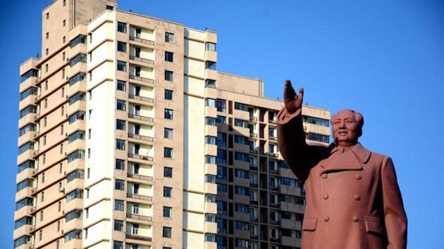 A statue of former Chinese chairman Mao Zedong is seen in front of a residential building in Dandong New Zone, Liaoning province, China on June 12, 2018.(REUTERS)