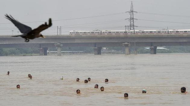 People swim across the swollen Yamuna river, in New Delhi on Sunday, July 29, 2018. (PTI) People swim across the swollen Yamuna river, in New Delhi on Sunday, July 29, 2018. (PTI)