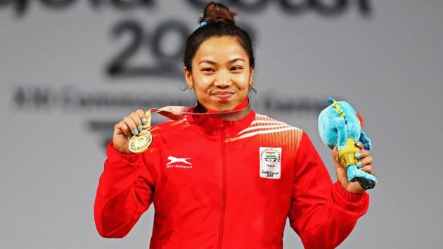 Mirabai Chanu celebrates on the podium after the Weightlifting Women's 48kg Final at the 2018 Commonwealth Games.(Getty Images)