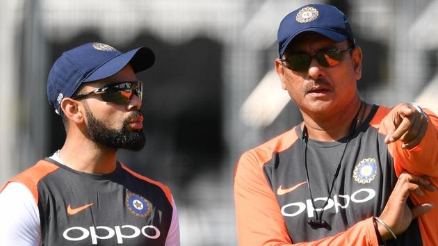 India's captain Virat Kohli (L) talks with India's head coach Ravi Shastri (R) during a practice session. (AFP)