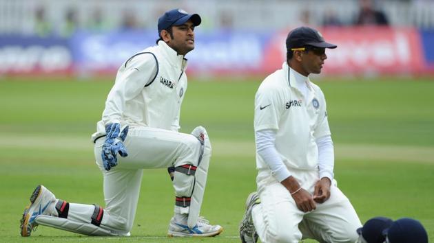 MS Dhoni (L) and Rahul Dravid react after dropping Jonathan Trott of England during the first test match between England and India at Lord's Cricket Ground on July 21, 2011 in London, England.(Getty Images)