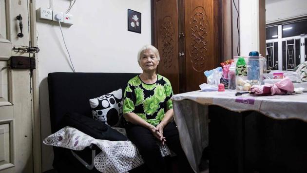 A resident waits while her toilet gets repaired by the volunteers. One resident, Mr Wong said volunteers had fixed his television and also helped him and others write letters to officials over local concerns. Another resident, Mr Cheng said he was too preoccupied with daily struggles to join any of the group’s activities, but did not mind the volunteers’ pro-democracy ideas. “As long as it doesn’t hurt me, that’s fine.” (Isaac Lawrence / AFP)