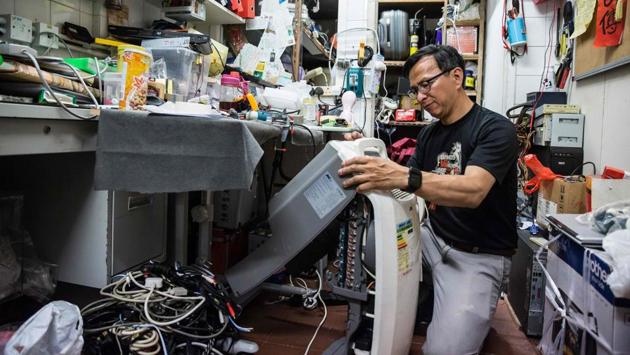 Alung Wong, a volunteer electrician repairs a dehumidifier. Fixing Hong Kong is one of the best-known community groups to have grown out of the rallies. Other small-scale projects, from urban rooftop gardens to rural farms, have also been set up by activists. (Isaac Lawrence / AFP)