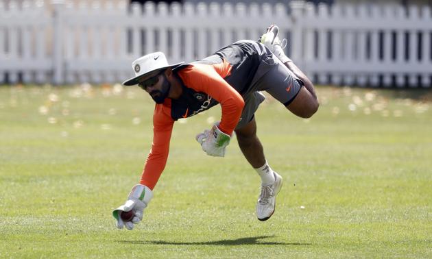 India's wicketkeeper Dinesh Karthik takes a ball during a training session at Lord's Cricket ground (AP)