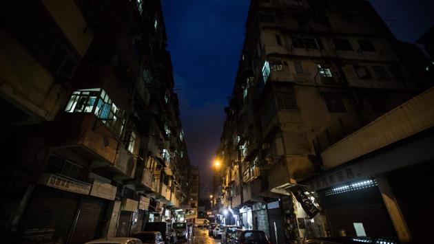 Volunteers visit these homes in the To Kwa Wan neighbourhood each week, making appointments for DIY jobs and offering repair services for free, with residents usually paying for their own replacement materials. They work in pairs, one fixing, the other chatting. Sometimes the conversation turns to politics, other times not. (Isaac Lawrence / AFP)