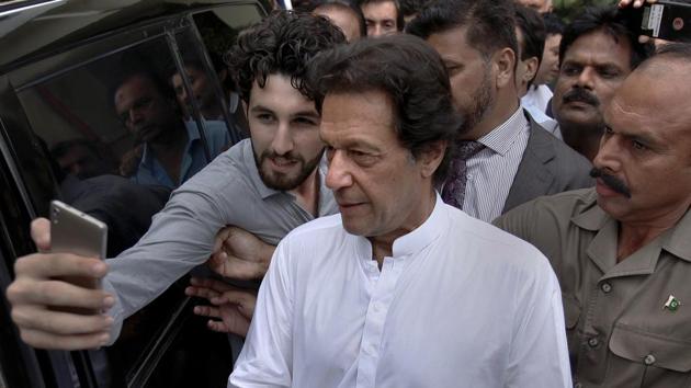A Pakistani takes selfie with Imran Khan, center, head of the Pakistan Tehreek-e-Insaf party, as he leaves a party meeting in Islamabad, Pakistan, Monday, Aug. 6, 2018. (AP Photo) A Pakistani takes selfie with Imran Khan, center, head of the Pakistan Tehreek-e-Insaf party, as he leaves a party meeting in Islamabad, Pakistan, Monday, Aug. 6, 2018. (AP Photo)