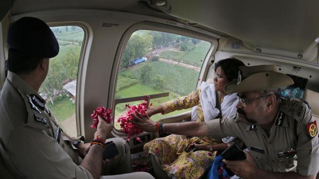 Government and police officials throw rose petals on Kanwarias, worshipper of Hindu god Shiva, from a helicopter near Meerut. Kanwarias are devotees performing a ritual pilgrimage in which they walk, clad in saffron, carrying ornately decorated canisters of the sacred water of the Ganga River over their shoulders, to take it back to the temples in their home towns, during the Hindu month of Shravana. (Rajesh Kumar Singh / AP) Government and police officials throw rose petals on Kanwarias, worshipper of Hindu god Shiva, from a helicopter near Meerut. Kanwarias are devotees performing a ritual pilgrimage in which they walk, clad in saffron, carrying ornately decorated canisters of the sacred water of the Ganga River over their shoulders, to take it back to the temples in their home towns, during the Hindu month of Shravana. (Rajesh Kumar Singh / AP)