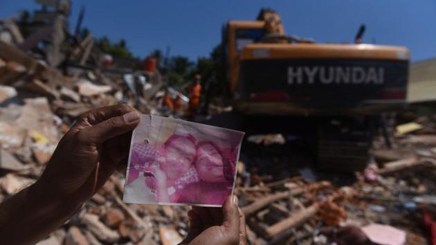 A resident shows a photo of missing victims believed to be trapped inside a collapsed building, as rescue workers continue searching after Sunday’s earthquake in Pemenang, North Lombok, Indonesia. Another aftershock rocked Indonesia’s Lombok on Thursday, sparking fresh panic on the tropical tourist island after a series of tremors in the past two weeks. (Zabur Karuru / Antara Foto / REUTERS) A resident shows a photo of missing victims believed to be trapped inside a collapsed building, as rescue workers continue searching after Sunday’s earthquake in Pemenang, North Lombok, Indonesia. Another aftershock rocked Indonesia’s Lombok on Thursday, sparking fresh panic on the tropical tourist island after a series of tremors in the past two weeks. (Zabur Karuru / Antara Foto / REUTERS)
