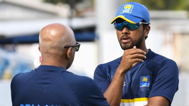 Dinesh Chandimal (R) chat with Chandika Hathurusingha (L) of Sri Lanka take part in a training session one day before the 3rd Test between West Indies and Sri Lanka at Kensington Oval, Bridgetown, Barbados, on June 22, 2018.(AFP)