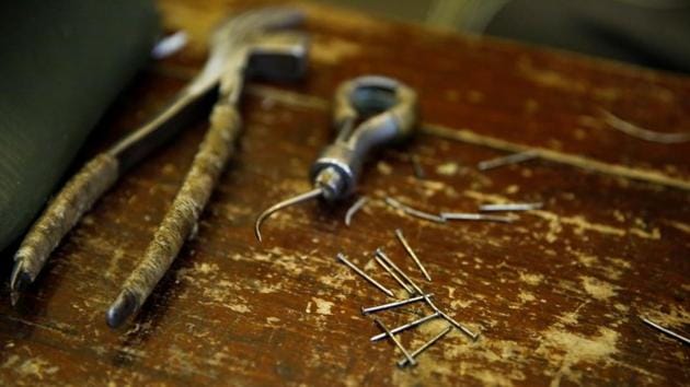 Nails and tools used in the production of 'thousand-layer' cloth shoes lie on a bench at the demonstration workshop. In 2008, Neiliansheng’s qiancengdi cloth shoe craftsmanship was put on the national intangible cultural heritage list. (Thomas Peter / REUTERS) Nails and tools used in the production of 'thousand-layer' cloth shoes lie on a bench at the demonstration workshop. In 2008, Neiliansheng’s qiancengdi cloth shoe craftsmanship was put on the national intangible cultural heritage list. (Thomas Peter / REUTERS)