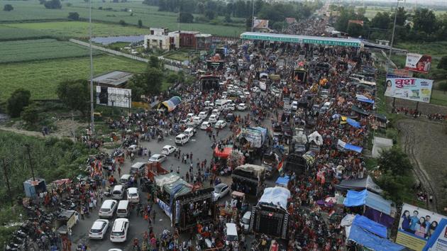Kanwarias walk past a toll gate on a national highway during a religious pilgrimage near Meerut. (AP File/Representative image) Kanwarias walk past a toll gate on a national highway during a religious pilgrimage near Meerut. (AP File/Representative image)