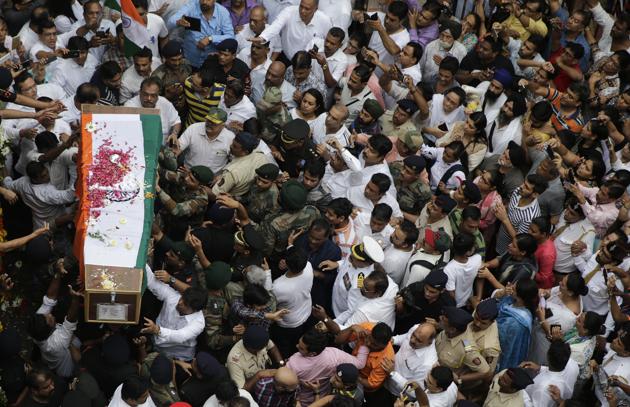 People carry the coffin containing the body of Indian Army Major Kaustubh Rane, who was killed in a gun battle Tuesday in Kashmir, during his funeral procession outside his home in Mumbai, India. (AP Photo) People carry the coffin containing the body of Indian Army Major Kaustubh Rane, who was killed in a gun battle Tuesday in Kashmir, during his funeral procession outside his home in Mumbai, India. (AP Photo)