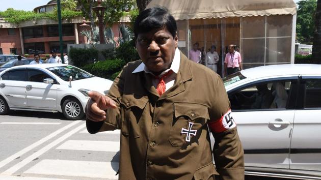 Telugu Desam Party MP and former actor Naramalli Sivaprasad who is known to make appearances donning costumes of famous characters turned up as Adolf Hitler in Parliament. Sivaprasad was protesting to demand special category status for Andhra Pradesh. (AFP) Telugu Desam Party MP and former actor Naramalli Sivaprasad who is known to make appearances donning costumes of famous characters turned up as Adolf Hitler in Parliament. Sivaprasad was protesting to demand special category status for Andhra Pradesh. (AFP)