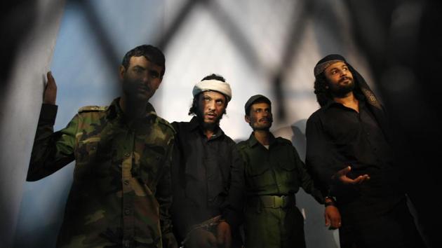 Suspected al-Qaida militants stand trial at a state security court in Sanaa. To think of al-Qaida as a terror group is to miss its other reality. For many Yemenis, it is simply a faction on the ground — a very effective one, well-armed and battle-hardened. Over the years, AQAP has woven itself into society by building ties with tribes, buying loyalties and marrying into major families. Power players often see it as a useful tool. (Hani Mohammed / AP File) Suspected al-Qaida militants stand trial at a state security court in Sanaa. To think of al-Qaida as a terror group is to miss its other reality. For many Yemenis, it is simply a faction on the ground — a very effective one, well-armed and battle-hardened. Over the years, AQAP has woven itself into society by building ties with tribes, buying loyalties and marrying into major families. Power players often see it as a useful tool. (Hani Mohammed / AP File)