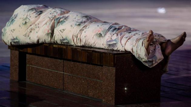 Dozing upon newspapers, blankets, or nothing at all, people sought relief from a night breeze blowing off the Huangpu River, which flows through the city centre. (Johannes Eisele / AFP) Dozing upon newspapers, blankets, or nothing at all, people sought relief from a night breeze blowing off the Huangpu River, which flows through the city centre. (Johannes Eisele / AFP)