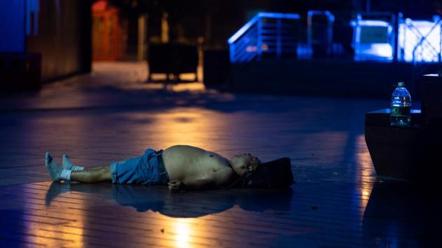 A man spends the hot night sleeping on the pavement. Many homes in some of Shanghai’s low-rise older neighbourhoods lack air conditioning, while residents that do have it will often seek ways to keep electricity bills from skyrocketing during summer. (Johannes Eisele / AFP) A man spends the hot night sleeping on the pavement. Many homes in some of Shanghai’s low-rise older neighbourhoods lack air conditioning, while residents that do have it will often seek ways to keep electricity bills from skyrocketing during summer. (Johannes Eisele / AFP)