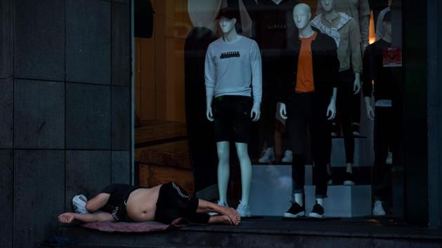 Some bivouacked in nearby People’s Square -- Shanghai’s main park -- or snored while curled up outside clothing-store windows as mannequins stood guard inside. (Johannes Eisele / AFP) Some bivouacked in nearby People’s Square -- Shanghai’s main park -- or snored while curled up outside clothing-store windows as mannequins stood guard inside. (Johannes Eisele / AFP)