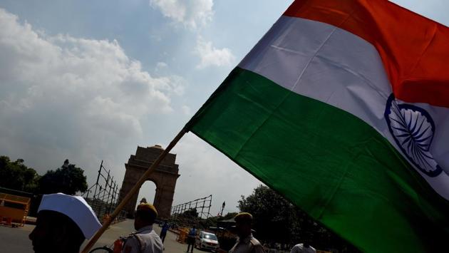 A supporter of Congress party holds the national flag during the tricolour march in New Delhi on August 9, 2018. The tricolour march was organised by the Seva Dal which is the grassroots front organisation of Congress on the occasion of the 76th anniversary of the ‘Quit India Movement.’ (Money Sharma / AFP) A supporter of Congress party holds the national flag during the tricolour march in New Delhi on August 9, 2018. The tricolour march was organised by the Seva Dal which is the grassroots front organisation of Congress on the occasion of the 76th anniversary of the ‘Quit India Movement.’ (Money Sharma / AFP)