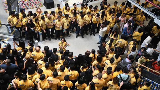 Ikea workers wait to welcome customers at the entrance of the new IKEA store in Hyderabad. (Noah Seelam / AFP)