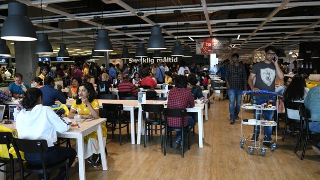 Customers eats at a restaurant at the new IKEA store in Hyderabad. To try and ensure it recoups its $1.5-billion investment, the Swedish company has tweaked its offerings to suit Indian tastes, starting with the restaurant, where “Smaklig Maltid -- ‘Enjoy your Meal’ in Swedish” is written on the wall. (Noah Seelam / AFP)