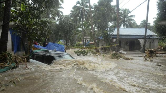 A car is submerged as roads and houses are engulfed in water following heavy rain and landslide in Kozhikode.(AP Photo)