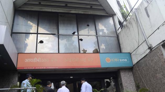 Even banks fell victim to the wrath of Marathas as protestors pelted stone on the IDBI bank office on FC road, which had remained open despite the bandh. (Ravindra Joshi/HT photo) 