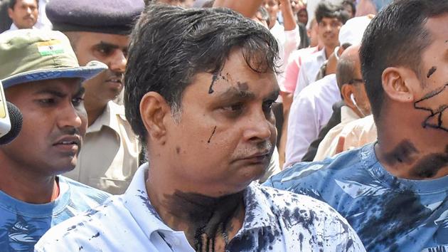 Main accused in the Muzaffarpur shelter home case Brajesh Thakur, after someone threw ink on his face while he was being taken to a special POCSO court, in Muzaffarpur, Bihar on August 8, 2018. (PTI) Main accused in the Muzaffarpur shelter home case Brajesh Thakur, after someone threw ink on his face while he was being taken to a special POCSO court, in Muzaffarpur, Bihar on August 8, 2018. (PTI)